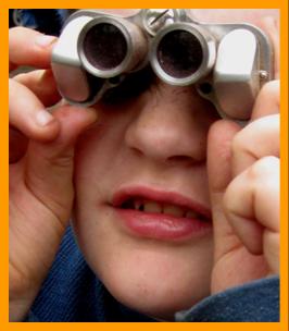 Child Looking Through Miniature Binoculars