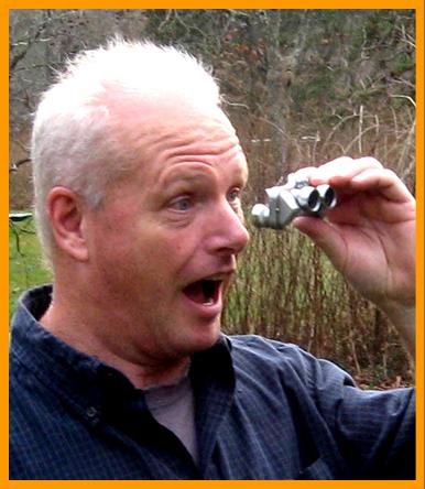 Man amazed by his miniature binoculars