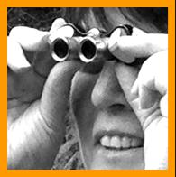 Woman looking with miniture binoculars