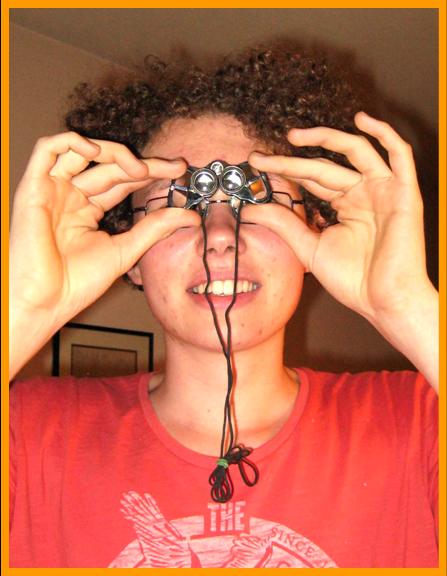 Young Man using miniature binoculars