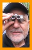 Man looking through Miniature Binoculars