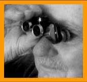 Gentleman Looking throught Miniature Binoculars. www.miniaturebinoculars.com