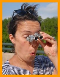 Wild haired woman amazed by view through binoculars. 
Woman using binoculars.
Frau mit fernglas.
Femme utilisant de jumelles.
Mujer usando binoculares.
Kvinna som anvander kikare.
Donna che usa il binocolo.
Vrouw met verrekijker.
Kvinnesom bruker kikkert.
Kobieta uzywajacy lornetka.
Zena pouzivajieci dalekohled.
Kvinde ved hjaelp af kikkert.