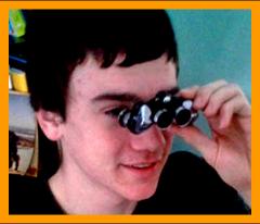 Young boy looking through pocket binoculars