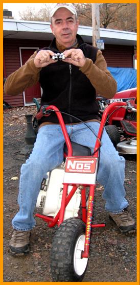 Man on mini bike with Minil Binoculars