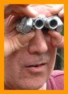 Puzzled man using Binoculars