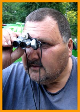 Man Searching for Bargains with Binoculars