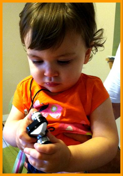 Young Child Playing with Milniature Binoculars