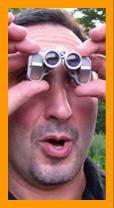 Surprised man with Miniature binoculars