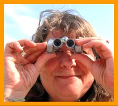 Smiling Woman enjoying miniature binoculars