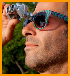 Man in Colorful Sunglases Looking Through Binoculars