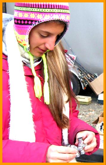Woman Examining Miniature Binoculars in the cold