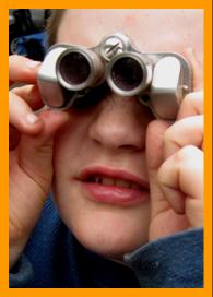 Cute Boy Looking through Binoculars
