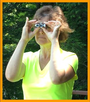 Woman using Miniature Binoculars