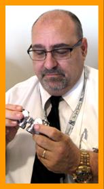 Man Examining Miniature Binoculars