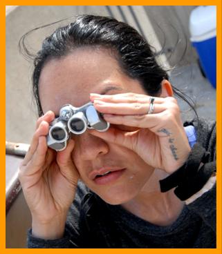 Tatooed Woman with micro binoculars