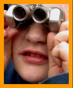 Young man looking theough binoculars