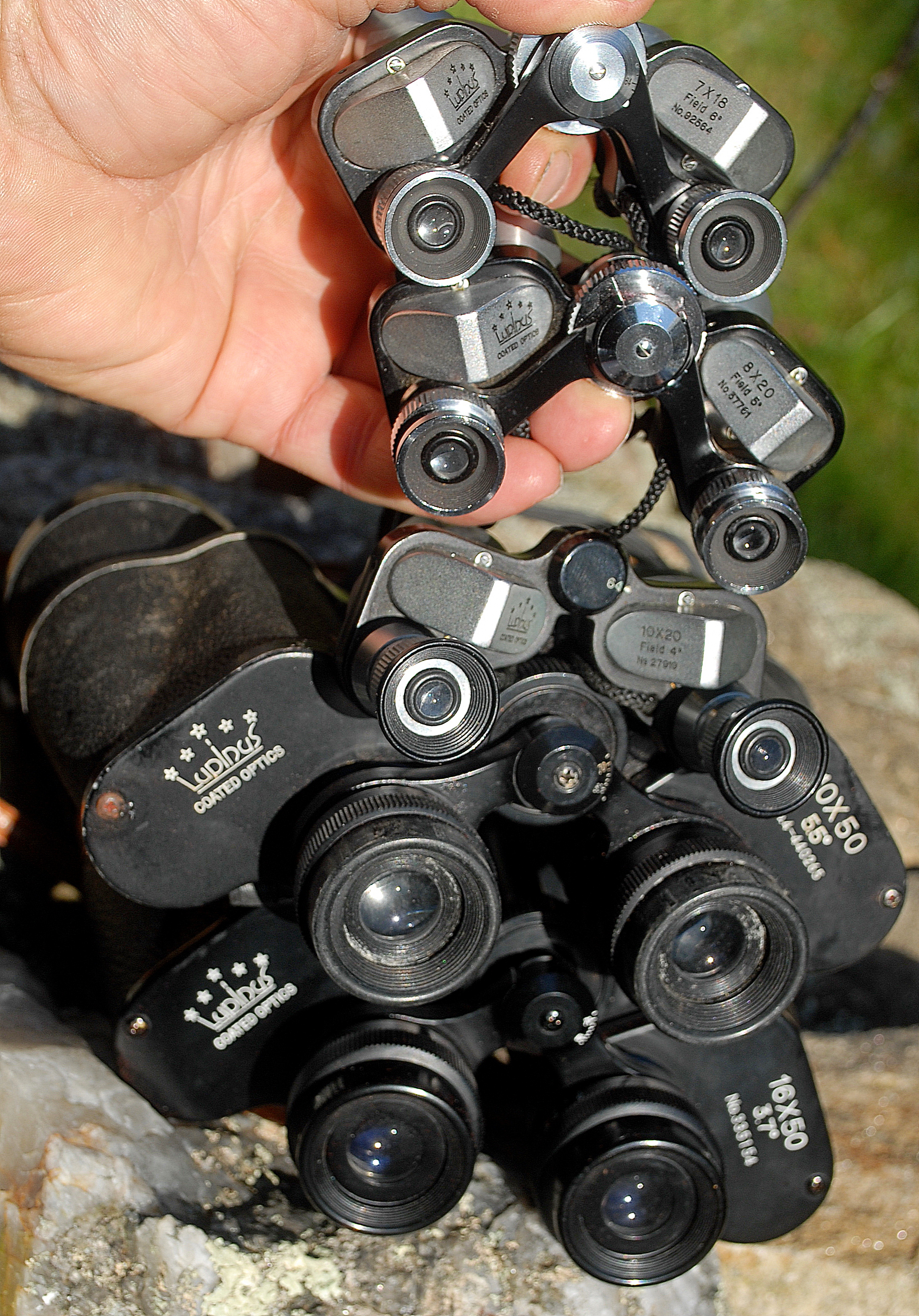 Man Viewing With Tiny Binoculars