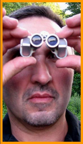 Man Viewing With Tiny Binoculars