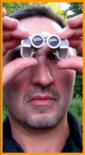 Man Viewing With Tiny Binoculars