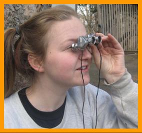 Cute Young Woman With Miniature Binoculars