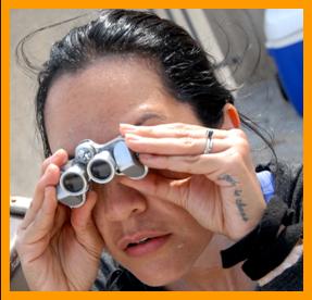 Tatooed Woman with micro binoculars