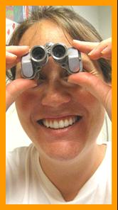 Cute nurse looking through binoculars