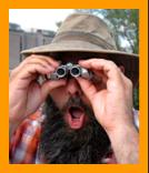 Amazed man using small binoculars