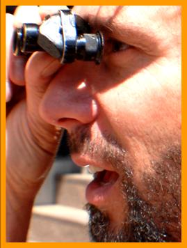 Bearded Man Using Small Binoculars. 
Man using binoculars.
Man with binoculars.
Homme utilisant ses jumelles.
Man mit seinem fernglas.
Hombre usando sus binoculares.
Hombre usando sus prisnmaticos.
Uomo che usa il suo binocolo. 
Man avander sin kikare.
Man die zijn verrekijker gebruikt.
Durbununu kullananadam.
Ember hasznalja a tavcsovet.
Mezczyznz uzwajacy lornetki.
Man, de bruger sin kikkert.
Mies kiikareillaan.
Muz pomoci sveho dalekohkedu.